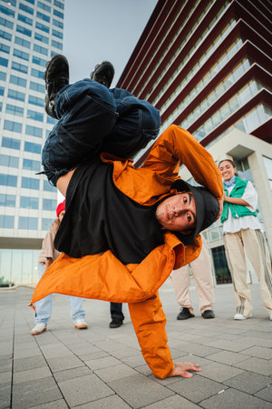 Urban breakdancer performing an impressive freeze move with skillful precision and energyの写真素材