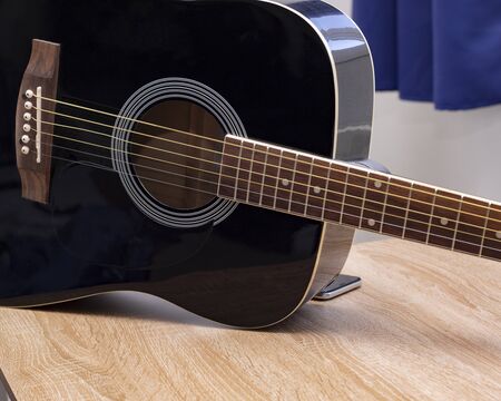Acoustic guitarist playing. Musical instrument with executable hands.
