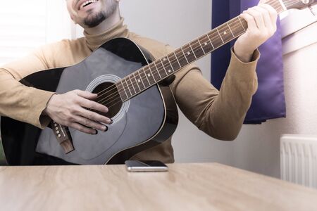 Acoustic guitarist playing. Musical instrument with executable hands.