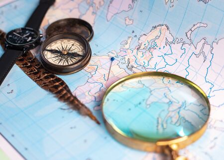 Magnifying glass and compass on a map. travel conceptの写真素材