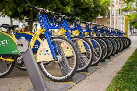 Group of many public city bicycles parked in rack row. Smart eco friendly transportのeditorial素材