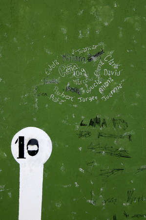 Green wall with engraved and graffiti textの写真素材