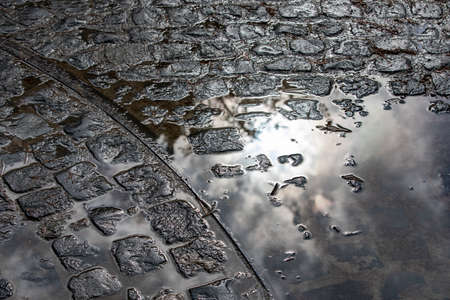 charcodde water on cobblestones after rainの写真素材