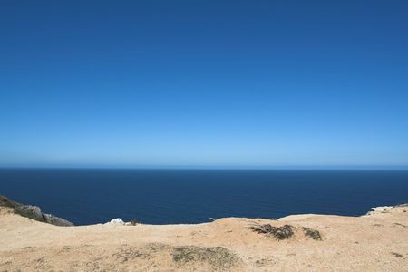 Edge of Espichel Cape facing the Atlantic Ocean horizonの写真素材