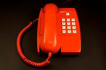 red telephone isolated on blackの写真素材