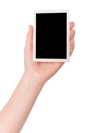 Hand holding a photograph isolated on a white backgroundの写真素材
