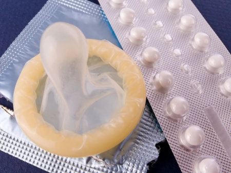 Birth Control Pills and a Condom. Contraception methods.の写真素材