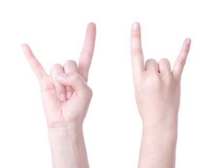 Horns hand sign isolated on white background の写真素材