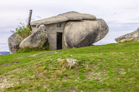 Casa do Penedo, a house built between huge rocks on top of a mountain in Fafe, Portugal. Commonly considered one of the strangest houses in the world.のeditorial素材