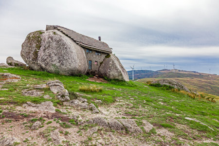 Casa do Penedo, a house built between huge rocks on top of a mountain in Fafe, Portugal. Commonly considered one of the strangest houses in the world.のeditorial素材