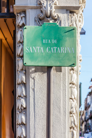 A street sign showing Rua de Santa Catarina, the name of the most commercial street of the city of Porto, where large brands locate their stores. Porto, Portugal.のeditorial素材