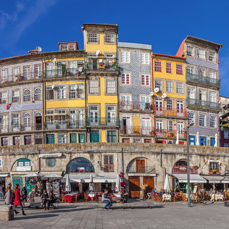 Porto, Portugal. December 29, 2014: The typical colorful buildings of the Ribeira District with the popular shops, restaurants and bars built in the stone wall. Unesco World Heritage Site.のeditorial素材