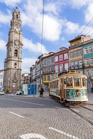 Porto, Portugal. January 5, 2015: The old tram passes by the Clerigos Tower, one of the landmarks and symbols of the city. Unesco World Heritage Siteのeditorial素材