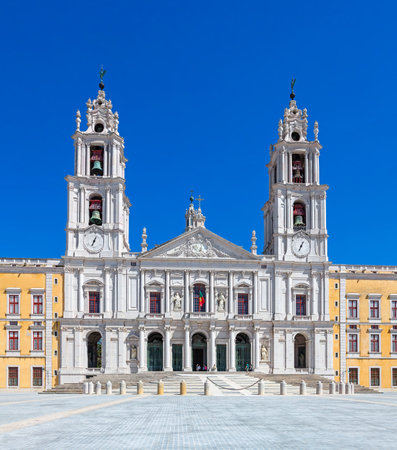 Mafra, Portugal - September 02, 2014: Tourists stroll in front of the Mafra National Palace, Convent and Basilica. Franciscan Religious Order. Baroque architecture.のeditorial素材