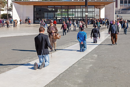 Sanctuary of Fatima, Portugal, March 07, 2015 - Devotees walk the Penitential Path on knees for vows made to Our Lady after the fulfillment of requests. Fatima is a major Marian Shrine for Catholicsのeditorial素材