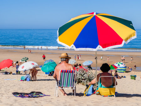 Almada, Portugal - July, 2015: Senior couple enjoying a day at the Fonte da Telha Beach in the Costa da Caparica coast, the preferred coast for Lisboans to beach.のeditorial素材