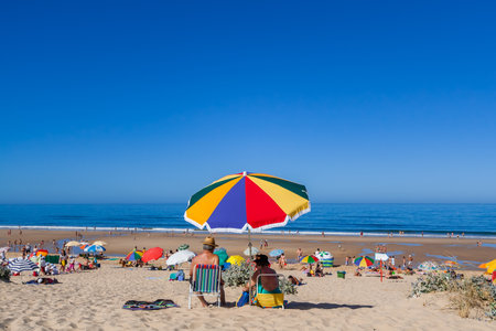 Almada, Portugal - July, 2015: Senior couple enjoying a day at the Fonte da Telha Beach in the Costa da Caparica coast, the preferred coast for Lisboans to beach.のeditorial素材