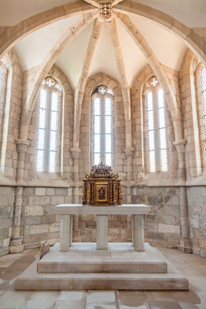 Santarem, Portugal. September 11, 2015: The aisle, altar and a gilded baroque tabernacle in the medieval church of Santa Cruz. 13th century Gothic Architecture. Santarem, Portugal.のeditorial素材