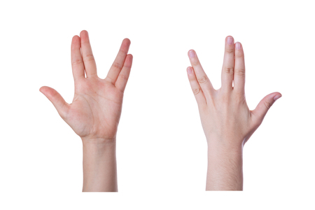Hand gesture for the Vulcan salute or greeting, and also the Bikat Cohanim or Kohanim priestly blessing for the jews, isolated on white backgroundの写真素材