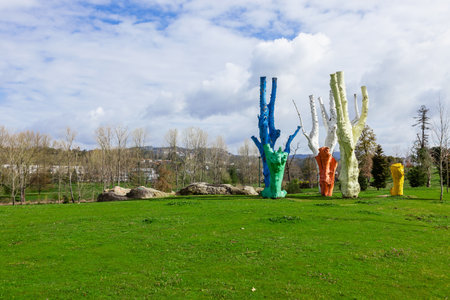 Vila Nova de Famalicao, Portugal - March 31, 2018: Urban art made of colorful painted dead trees in Parque da Devesa Urban Park.のeditorial素材