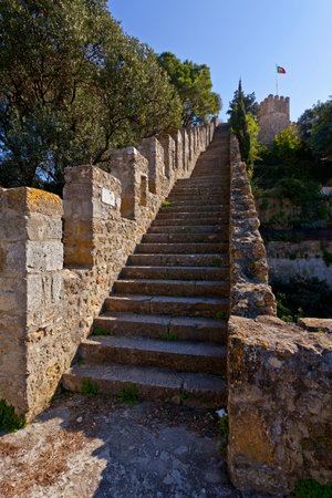 Lisbon, Portugal - February 1, 2013: Castelo de Sao Jorge aka Saint George Castle. Staircase on the Defensive walls with view of the wallwalk, battlements, ramparts, merlons and crenels in the towersのeditorial素材