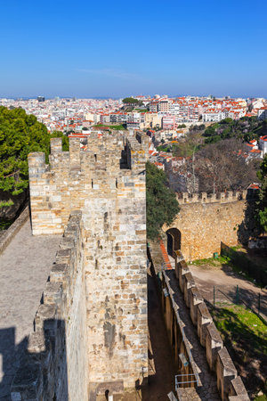 Lisbon, Portugal - February 1, 2017: Castelo de Sao Jorge aka Saint George Castle. Defensive walls with a view of the wallwalk, battlements, ramparts, merlons and crenels in the towersのeditorial素材