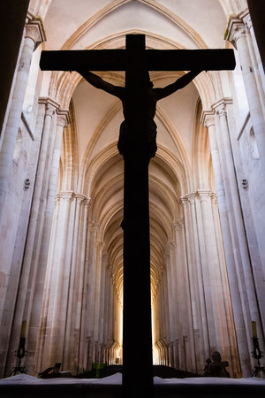 Alcobaca, Portugal - July 17, 2017: Crucifix with Jesus Christ nailed to cross. Monastery of Alcobaca Abbey Churh Altar, a masterpiece of the Medieval Gothic architecture. Cistercian Religious Orderのeditorial素材
