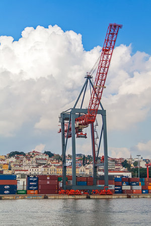 Lisbon, Portugal - November 05, 2018: Porto de Lisboa or International Port of Lisbon in the Tagus River. Crane and shipping containersのeditorial素材