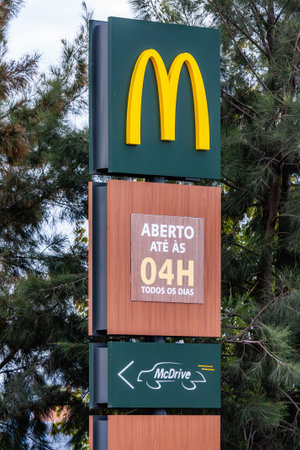 Coina, Portugal - October 23, 2019: Signboard of McDonaldâs with Golden Arches at the entrance of a McDonalds restaurant informing of the McDrive drive thru service and serving hoursのeditorial素材