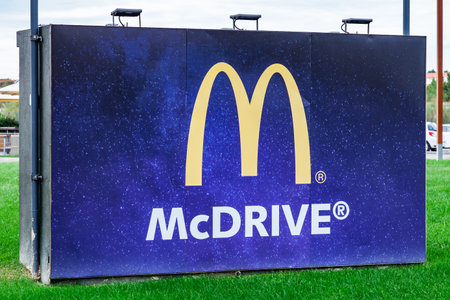 Coina, Portugal - October 23, 2019: McDonaldâs billboard with Golden Arches promoting the McDrive drive thru service at the entrance of a McDonalds restaurantのeditorial素材