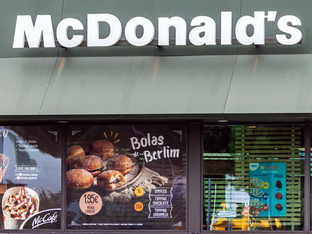 Coina, Portugal - October 23, 2019: Storefront of the McDonalds restaurant and McCafe advertising a sweet pastry called Bolas de Berlim, a regional Portuguese specialtyのeditorial素材