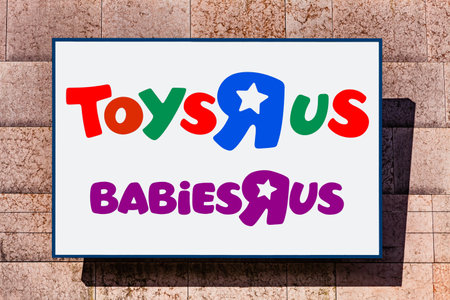 Almada, Portugal - October 24, 2019: Signboard advertising the ToysRus and BabiesRus, babies, and children toy store in a shopping center or shopping mall exterior wall.のeditorial素材