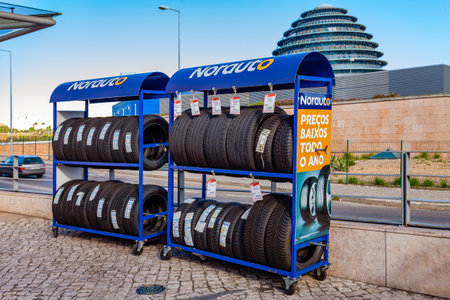 Almada, Portugal - October 24, 2019: Tires on rack at Norauto car or auto parts shop and service station or auto repair shop in Almada Forum shopping mall or center. Norauto is a French companyのeditorial素材