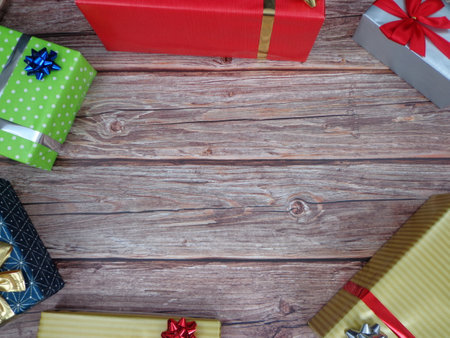 Christmas motifs and celebrations with gifts on a wooden background, with space to place textの写真素材