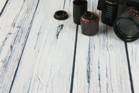 Old photo camera with flash mounted on woodenの写真素材