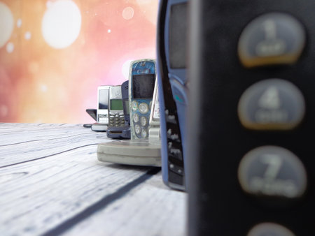 Old mobile phones arranged on woodenの写真素材