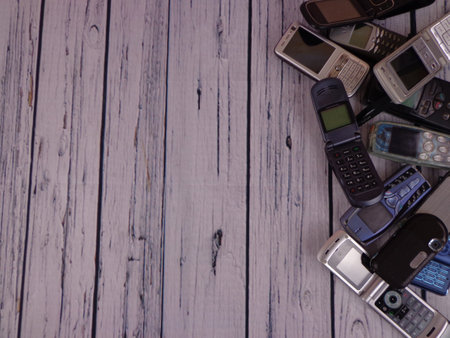Old mobile phones arranged on woodenの写真素材