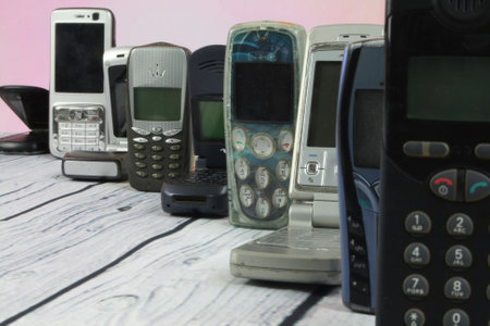 Old mobile phones arranged on woodenの写真素材