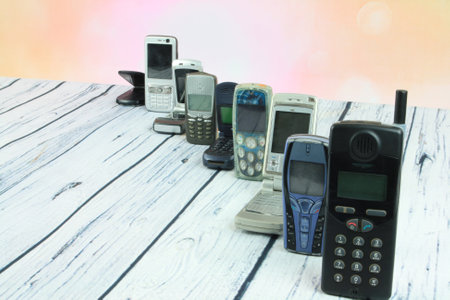 Old mobile phones arranged on woodenの写真素材