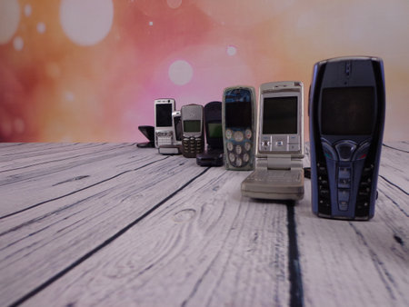 Old mobile phones arranged on woodenの写真素材