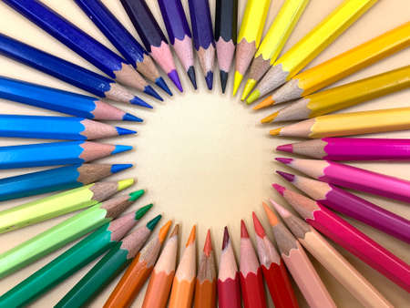 Colored pencils placed in a circle, empty space to place textの写真素材