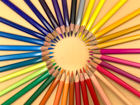 Colored pencils placed in a circle, empty space to place textの写真素材