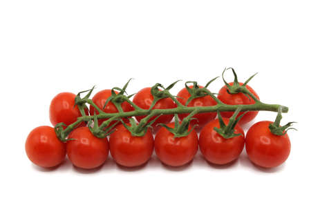 Cherry tomatoes in deep red branchの写真素材