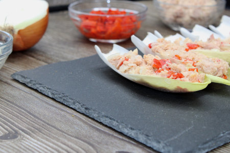 Endives dish filled with tuna, red pepper and onionの写真素材