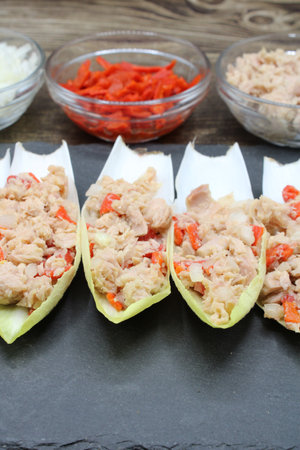 Endives dish filled with tuna, red pepper and onionの写真素材