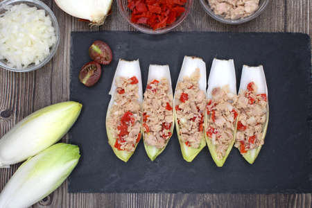 Endives filled with tuna, red pepper and onion seen from aboveの写真素材