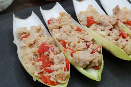 Endives dish filled with tuna, red pepper and onionの写真素材