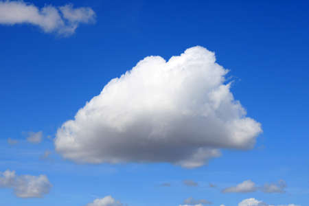 Lonely cloud over an intense blue skyの写真素材