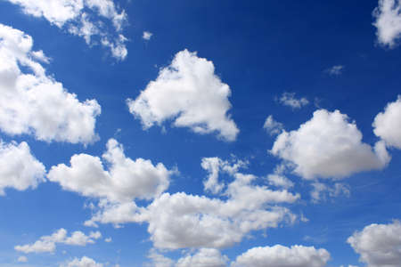 Clouds scattered over an intense blue skyの写真素材