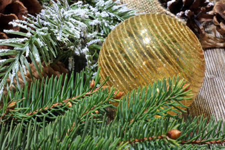 Christmas balls on a table with fir branches and pine conesの写真素材